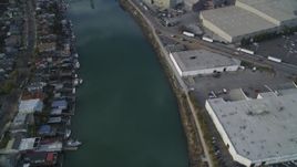 5K aerial stock footage of flying over estuary and warehouses, reveal factory, Fruitvale Bridge, Oakland Estuary, California Aerial Stock Footage | DFKSF06_003