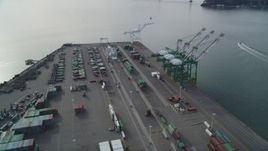 5K aerial stock footage of an orbit of the cargo cranes and shipping containers at the Port of Oakland, California Aerial Stock Footage | DFKSF06_019