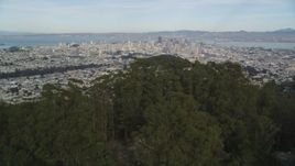 5K aerial stock footage tilt from Mount Sutro forest to reveal skyscrapers in Downtown San Francisco, California Aerial Stock Footage | DFKSF06_073