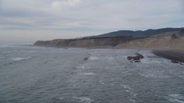 5K aerial stock of descending towards waves near coastal cliffs, Bolinas, California Aerial Stock Footage | DFKSF06_118