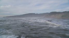 5K aerial stock footage of flying low over waves and rocky shallows near coastal cliffs, Bolinas, California Aerial Stock Footage | DFKSF06_121
