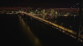 5K aerial stock footage approach the Bay Bridge with the city skyline in the distance, San Francisco, California, night Aerial Stock Footage | DFKSF07_002