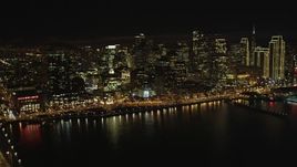 5K aerial stock footage tilt from bay to reveal Bay Bridge and Downtown San Francisco skyscrapers, California, night Aerial Stock Footage | DFKSF07_011