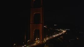 5K aerial stock footage of tilting from traffic on the Golden Gate Bridge to one of the towers, San Francisco, California, night Aerial Stock Footage | DFKSF07_036