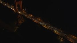 5K aerial stock footage tilt from Golden Gate Bridge tower to reveal heavy traffic, San Francisco, California night Aerial Stock Footage | DFKSF07_037