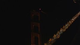 5K aerial stock footage of circling a tower on the historic Golden Gate Bridge, San Francisco, California, night Aerial Stock Footage | DFKSF07_040