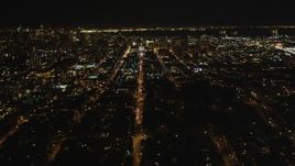 5K aerial stock footage of following Fulton Street, tilt to reveal city hall, Western Addition, San Francisco, California, night Aerial Stock Footage | DFKSF07_050