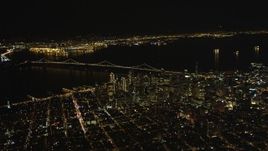 5K aerial stock footage of a wide view of the Bay Bridge and Downtown San Francisco skyscrapers, California, night Aerial Stock Footage | DFKSF07_064