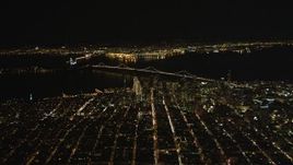 5K aerial stock footage of a high altitude view of Coit Tower, the Bay Bridge, and skyscrapers in Downtown San Francisco, California, night Aerial Stock Footage | DFKSF07_065