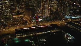 5K aerial stock footage of flying away from the Ferry Building to reveal Downtown San Francisco skyscrapers at night, California Aerial Stock Footage | DFKSF07_074