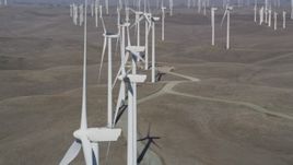 5K aerial stock footage of passing a field of windmills, Shiloh Wind Power Plant, Montezuma Hills, California Aerial Stock Footage | DFKSF08_084