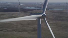 5K aerial stock footage orbit top of windmill, reveal more windmills, Shiloh Wind Power Plant, California Aerial Stock Footage | DFKSF08_086