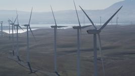 5K aerial stock footage of flying by row of windmills, Shiloh Wind Power Plant, Montezuma Hills, California Aerial Stock Footage | DFKSF08_088