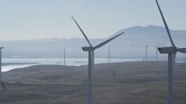 5K aerial stock footage of flying by tops of windmills at Shiloh Wind Power Plant, Montezuma Hills, California Aerial Stock Footage | DFKSF08_089