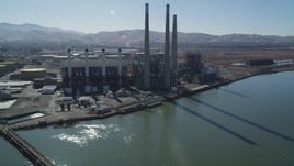5K aerial stock footage tilt from piers to reveal a power plant with smoke stacks in Pittsburg, California Aerial Stock Footage | DFKSF08_099