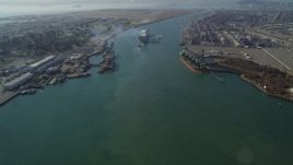 5K aerial stock footage of tilting from Oakland Inner Harbor revealing cargo ship in Port of Oakland, California Aerial Stock Footage | DFKSF09_017