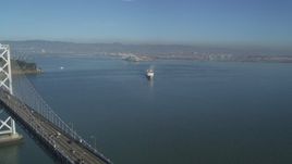 5K aerial stock footage fly over the Bay Bridge to reveal a cargo ship, San Francisco, California Aerial Stock Footage | DFKSF09_045