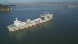 5K aerial stock footage of tracking a passing cargo ship to reveal the Bay Bridge, San Francisco, California Aerial Stock Footage | DFKSF09_046