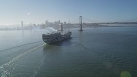 5K aerial stock footage track a cargo ship approaching the Bay Bridge, San Francisco, California Aerial Stock Footage | DFKSF09_047