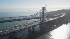 5K aerial stock footage of flying by the Bay Bridge and the new span under construction, California Aerial Stock Footage | DFKSF09_054