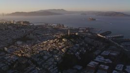 5K aerial stock footage of flying by Coit Tower in North Beach with a view of San Francisco Bay, California, sunset Aerial Stock Footage | DFKSF10_016