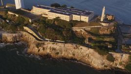 5K aerial stock footage of flying by and away from Alcatraz island prison in San Francisco, California, sunset Aerial Stock Footage | DFKSF10_020
