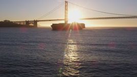 5K aerial stock footage of a cargo ship near Golden Gate Bridge, San Francisco, California, sunset Aerial Stock Footage | DFKSF10_021