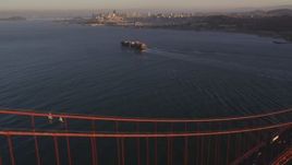 5K aerial stock footage of cargo ship on San Francisco Bay, seen from Golden Gate Bridge, San Francisco, California, sunset Aerial Stock Footage | DFKSF10_024