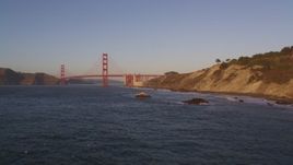 5K aerial stock footage descend to rock formations, approach Golden Gate Bridge, San Francisco, California, sunset Aerial Stock Footage | DFKSF10_026