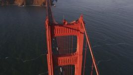 5K aerial stock footage approach tower on the Golden Gate Bridge and tilt to bird's eye of traffic in San Francisco, California, sunset Aerial Stock Footage | DFKSF10_029