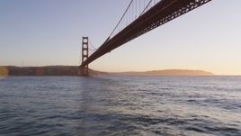 5K aerial stock footage of flying under the world famous Golden Gate Bridge, San Francisco, California, sunset Aerial Stock Footage | DFKSF10_032