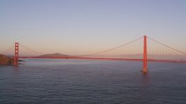 5K aerial stock footage of flying away from iconic Golden Gate Bridge in San Francisco, California, at sunset Aerial Stock Footage | DFKSF10_034