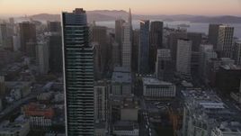 5K aerial stock footage orbit One Rincon Hill skyscraper, revealing Downtown San Francisco, California, sunset Aerial Stock Footage | DFKSF10_049