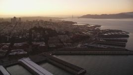 5K aerial stock footage pan across San Francisco Bay to reveal Coit Tower, Fisherman's Wharf, California, sunset Aerial Stock Footage | DFKSF10_062