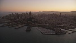 5K aerial stock footage of downtown skyscrapers and Coit Tower, reveal Pier 39, Fisherman's Wharf, San Francisco, California, twilight Aerial Stock Footage | DFKSF10_064