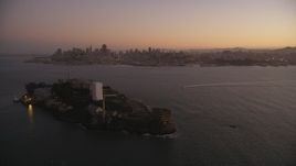 5K aerial stock footage of flying away from Alcatraz and the skyline of Downtown San Francisco, California, twilight Aerial Stock Footage | DFKSF10_067