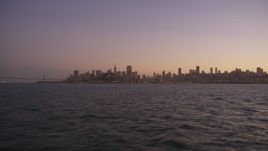 5K aerial stock footage of flying low over the bay with a view of Downtown San Francisco skyline, California, twilight Aerial Stock Footage | DFKSF10_070