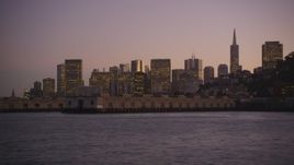 5K aerial stock footage of flying low over the bay by Coit Tower and Downtown San Francisco skyline, California, twilight Aerial Stock Footage | DFKSF10_073