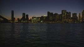 5K aerial stock footage fly low over bay, pan and approach Downtown San Francisco skyline, California, night Aerial Stock Footage | DFKSF10_095