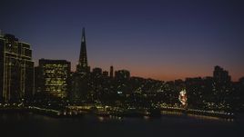 5K aerial stock footage of flying away from Transamerica Pyramid and skyscrapers in Downtown San Francisco, California, night Aerial Stock Footage | DFKSF10_098