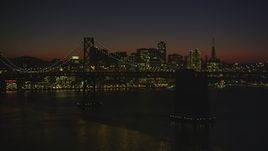 5K aerial stock footage of fly by Bay Bridge and city's skyline while ascending the Bay, Downtown San Francisco, California, night Aerial Stock Footage | DFKSF10_105