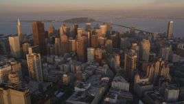 5K aerial stock footage approach skyscrapers and tilt to buildings below in Downtown San Francisco, California, sunset Aerial Stock Footage | DFKSF14_005