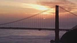 5K aerial stock footage of the setting sun behind the Golden Gate Bridge in San Francisco, California, sunset Aerial Stock Footage | DFKSF14_026
