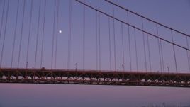 5K aerial stock footage of flying by the Golden Gate Bridge with a view of the moon, San Francisco, California, twilight Aerial Stock Footage | DFKSF14_035