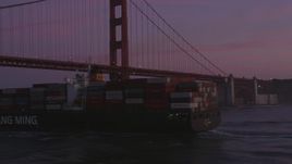 5K aerial stock footage orbit cargo ship and reveal Golden Gate Bridge, San Francisco, California, twilight Aerial Stock Footage | DFKSF14_041