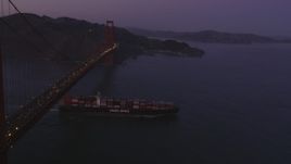 5K aerial stock footage fly over Golden Gate Bridge, reveal cargo ship, San Francisco, California, twilight Aerial Stock Footage | DFKSF14_042