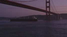 5K aerial stock footage approach oil tanker sailing under Golden Gate Bridge, San Francisco, California, twilight Aerial Stock Footage | DFKSF14_046