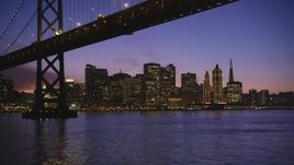 5K aerial stock footage of city skyscrapers, revealing Bay Bridge, Downtown San Francisco, California, twilight Aerial Stock Footage | DFKSF14_068
