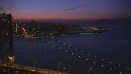 5K aerial stock footage of flying over Bay Bridge while focusing on Coit Tower, North Beach, San Francisco, California, twilight Aerial Stock Footage | DFKSF14_074