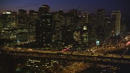 5K aerial stock footage of flying by Bay Bridge, with views of Downtown San Francisco skyscrapers, California, night Aerial Stock Footage | DFKSF14_077